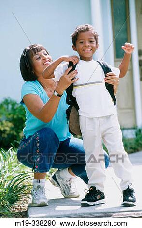 Woman helping her son with his bag mochila before to go to school View Large Photo Image Stock Image - Woman helping her son with his bag mochila before to go to school. Fotosearch