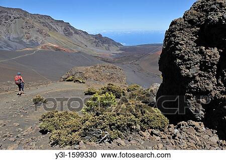 Stock Image - Woman hiking in the Haleakala crater, Maui Island, Hawaii Islands, USA. Fotosearch