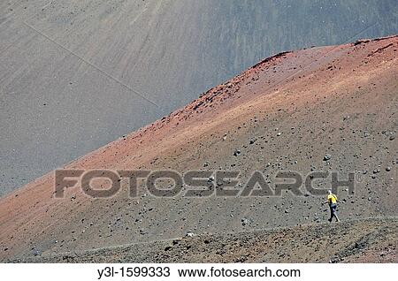 Stock Image - Woman hiking in the Haleakala crater, Maui Island, Hawaii Islands, USA. Fotosearch