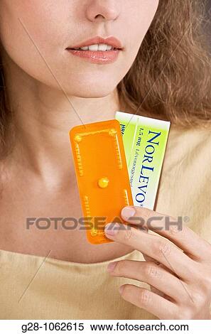 Stock Photography - Woman holdind the morning ater contraceptive pill. Fotosearch