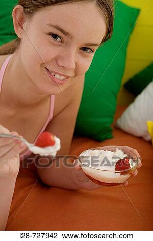 Stock Image - woman holding a bowl of ice cream. Fotosearch