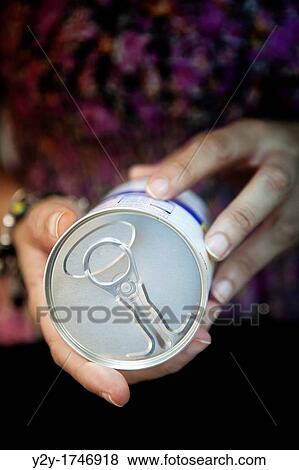 Woman holding a can View Large Photo Image Stock Photo - Woman holding a can. Fotosearch