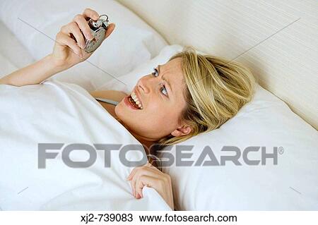 Woman holding a clock View Large Photo Image Stock Image - Woman holding a clock. Fotosearch