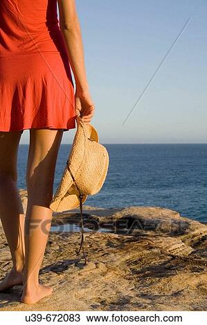 Woman holding a cowboy hat, standing next to the ocean. Sydney, Australia View Large Photo Image Stock Image - Woman holding a cowboy hat, standing next to the ocean. Sydney, Australia. Fotosearch