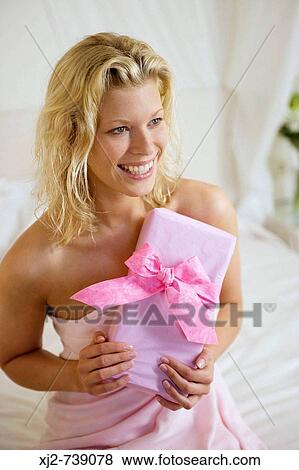 Woman holding a gift View Large Photo Image Stock Photo - Woman holding a gift. Fotosearch