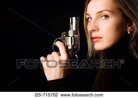 Woman holding a gun View Large Photo Image Stock Image - Woman holding a gun. Fotosearch