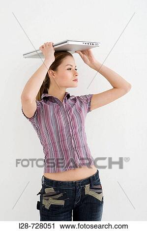woman holding a laptop View Large Photo Image Stock Image - woman holding a laptop. Fotosearch