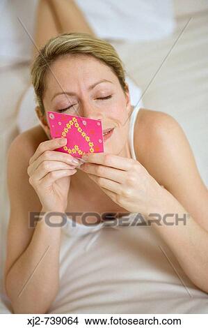 Picture - Woman holding a love card. Fotosearch