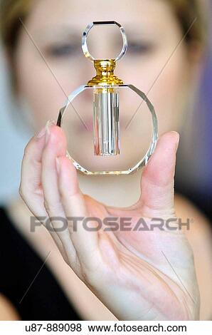 Stock Photo - Woman Holding a Perfume Bottle. Fotosearch
