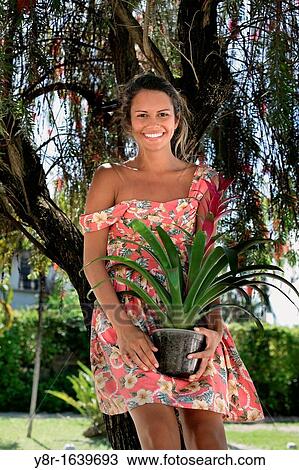 woman holding a plant View Large Photo Image Stock Image - woman holding a plant. Fotosearch