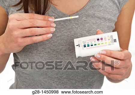 woman holding a urine analysis self test to test glucose for diabetes View Large Photo Image Stock Photo - woman holding a urine analysis self test to test glucose for diabetes. Fotosearch