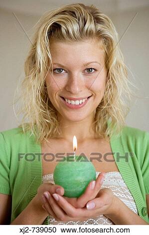 Woman holding an aromatic candle View Large Photo Image Stock Image - Woman holding an aromatic candle. Fotosearch