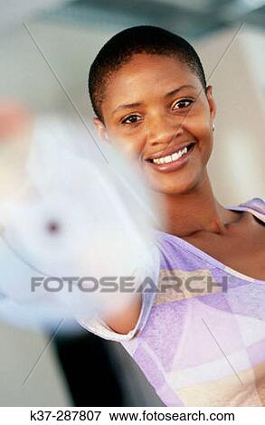 Woman holding cd to camera View Large Photo Image Stock Photo - Woman holding cd to camera. Fotosearch