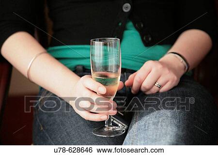 Stock Photograph - Woman holding champagne glass. Fotosearch