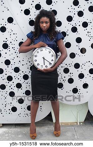 Woman holding clock View Large Photo Image Stock Photo - Woman holding clock. Fotosearch