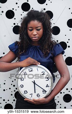 woman holding clock View Large Photo Image Stock Photo - woman holding clock. Fotosearch