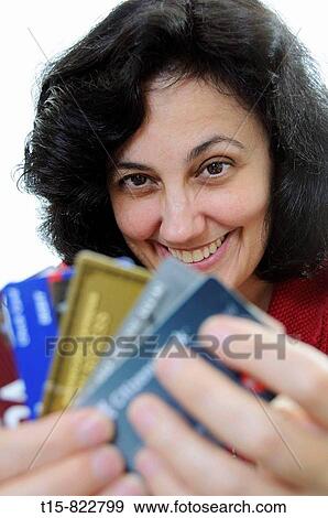 Stock Photo - woman holding credit cards smiling. Fotosearch