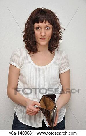 Stock Image - Woman holding empty wallet. Fotosearch