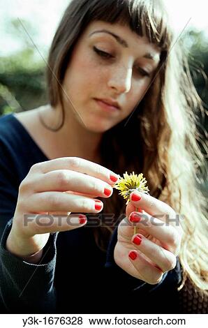 Stock Photo - Woman holding flower. Fotosearch
