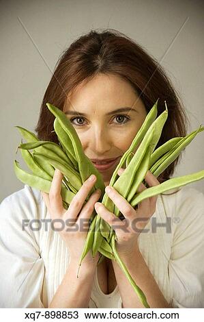 Woman holding green beans View Large Photo Image Stock Image - Woman holding green beans. Fotosearch