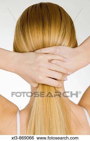 woman holding her hair View Large Photo Image Stock Photograph - woman holding her hair. Fotosearch