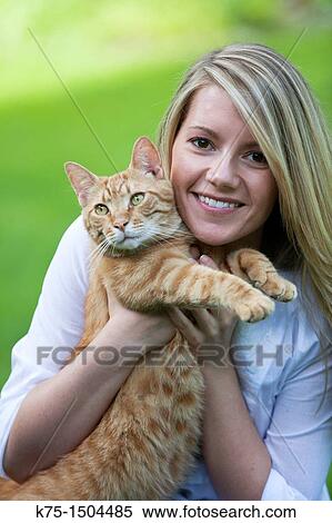 Woman holding her pet cat View Large Photo Image Stock Photography - Woman holding her pet cat. Fotosearch