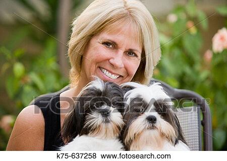 Woman holding her two pet dogs View Large Photo Image Stock Photo - Woman holding her two pet dogs. Fotosearch