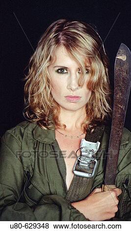 Woman holding machette in military clothing View Large Photo Image Stock Photo - Woman holding machette in military clothing. Fotosearch