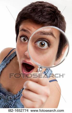 Woman holding magnifying glass View Large Photo Image Picture - Woman holding magnifying glass. Fotosearch