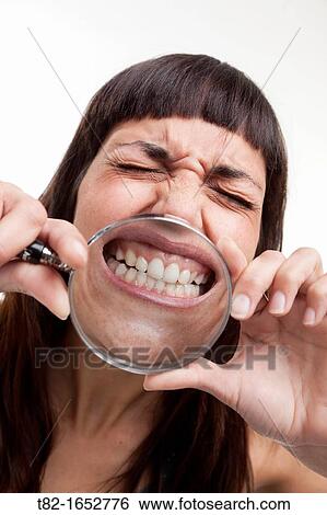 Woman holding magnifying glass View Large Photo Image Stock Photograph - Woman holding magnifying glass. Fotosearch
