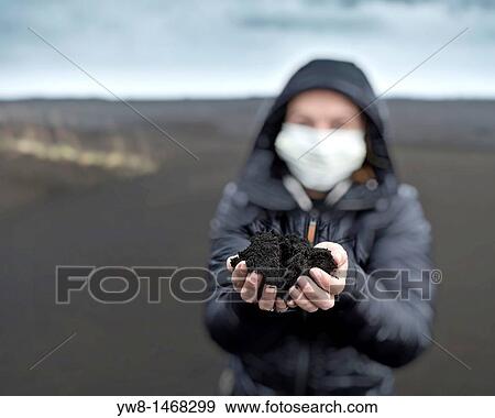 Woman holding new ash from recent Grimsvotn volcanic eruption, Iceland Skeidararsandur outwash plains covered with ashfall Eruption began on May 21, 2011 View Large Photo Image Stock Photo - Woman holding new ash from recent Grimsvotn volcanic eruption, Iceland Skeidararsandur outwash plains covered with ashfall Eruption began on May 21, 2011. Fotosearch
