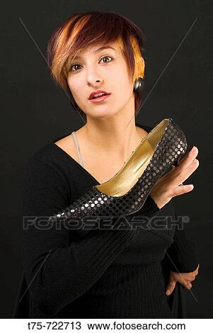 Woman holding shoe View Large Photo Image Stock Image - Woman holding shoe. Fotosearch