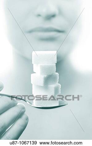 Woman holding spoon of sugar cube View Large Photo Image Stock Photo - Woman holding spoon of sugar cube. Fotosearch