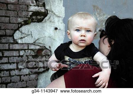 Woman holding toddler View Large Photo Image Stock Photo - Woman holding toddler. Fotosearch