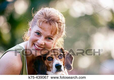 Woman hugging her dog View Large Photo Image Stock Photo - Woman hugging her dog. Fotosearch