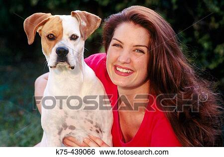 Woman hugging her pet dog View Large Photo Image Stock Photograph - Woman hugging her pet dog. Fotosearch