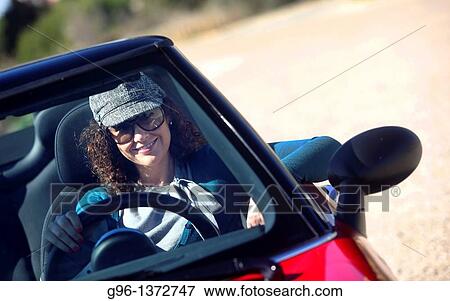 woman in a convertible relaxing at the beach View Large Photo Image Stock Photo - woman in a convertible relaxing at the beach. Fotosearch