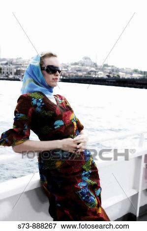 Stock Photo - Woman in a cruise along the Bosporus, Istanbul, Turkey. Fotosearch