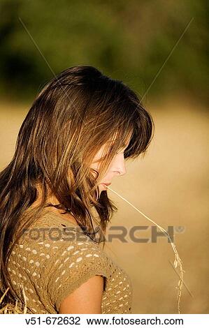 Woman in a field of wheat View Large Photo Image Stock Image - Woman in a field of wheat. Fotosearch