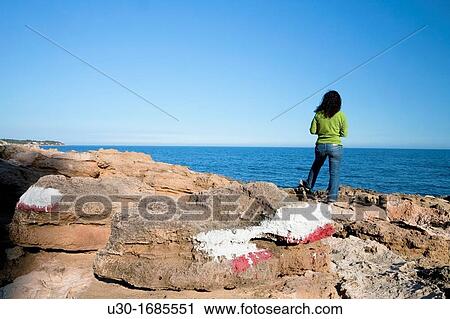 Woman in a GR footpath Landscape of Perello beach, and Mediterranean sea Tarragona province Spain View Large Photo Image Stock Image - Woman in a GR footpath Landscape of Perello beach, and Mediterranean sea Tarragona province Spain. Fotosearch