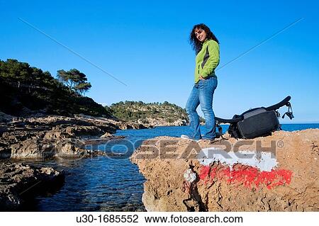 Woman in a GR footpath Landscape of Perello beach, and Mediterranean sea Tarragona province Spain View Large Photo Image Stock Image - Woman in a GR footpath Landscape of Perello beach, and Mediterranean sea Tarragona province Spain. Fotosearch