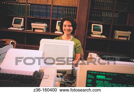 Woman in a library View Large Photo Image Stock Image - Woman in a library. Fotosearch