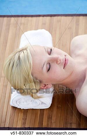 Woman in a massage by a pool View Large Photo Image Stock Photo - Woman in a massage by a pool. Fotosearch