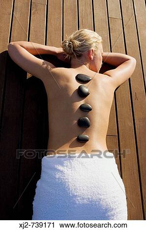 Woman in a Spa with stone therapy View Large Photo Image Stock Image - Woman in a Spa with stone therapy. Fotosearch