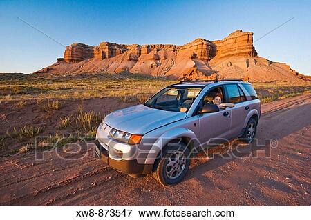 Woman in a SUV on a dirt road in Utah View Large Photo Image Stock Photo - Woman in a SUV on a dirt road in Utah. Fotosearch