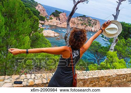 Picture - Woman in a viewpoint. Aigua Xelida, Palafrugell. Costa Brava, Gerona. Catalonia, Spain, Europe.. Fotosearch