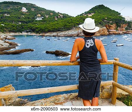 Stock Image - Woman in a viewpoint. Cala Aiguafreda. Begur. Costa Brava, Gerona. Catalonia, Spain, Europe.. Fotosearch