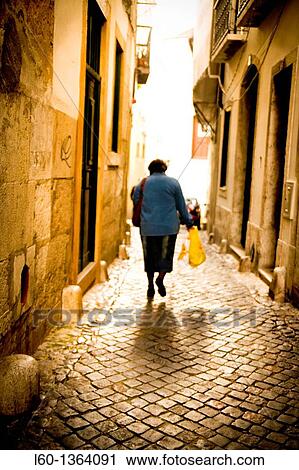 Stock Image - Woman in Alfama, Lisbon, Portugal. Fotosearch
