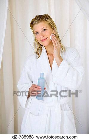 Woman in bathrobe cleaning her face View Large Photo Image Stock Photo - Woman in bathrobe cleaning her face. Fotosearch