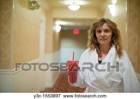 Woman in bathrobe in a hotel hallway View Large Photo Image Stock Photo - Woman in bathrobe in a hotel hallway. Fotosearch